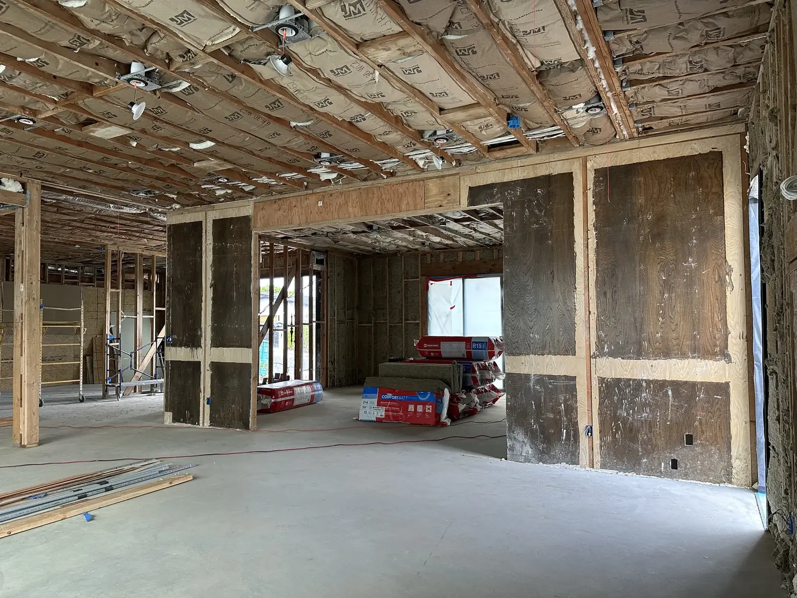 Open framing during construction, with damaged wood visible