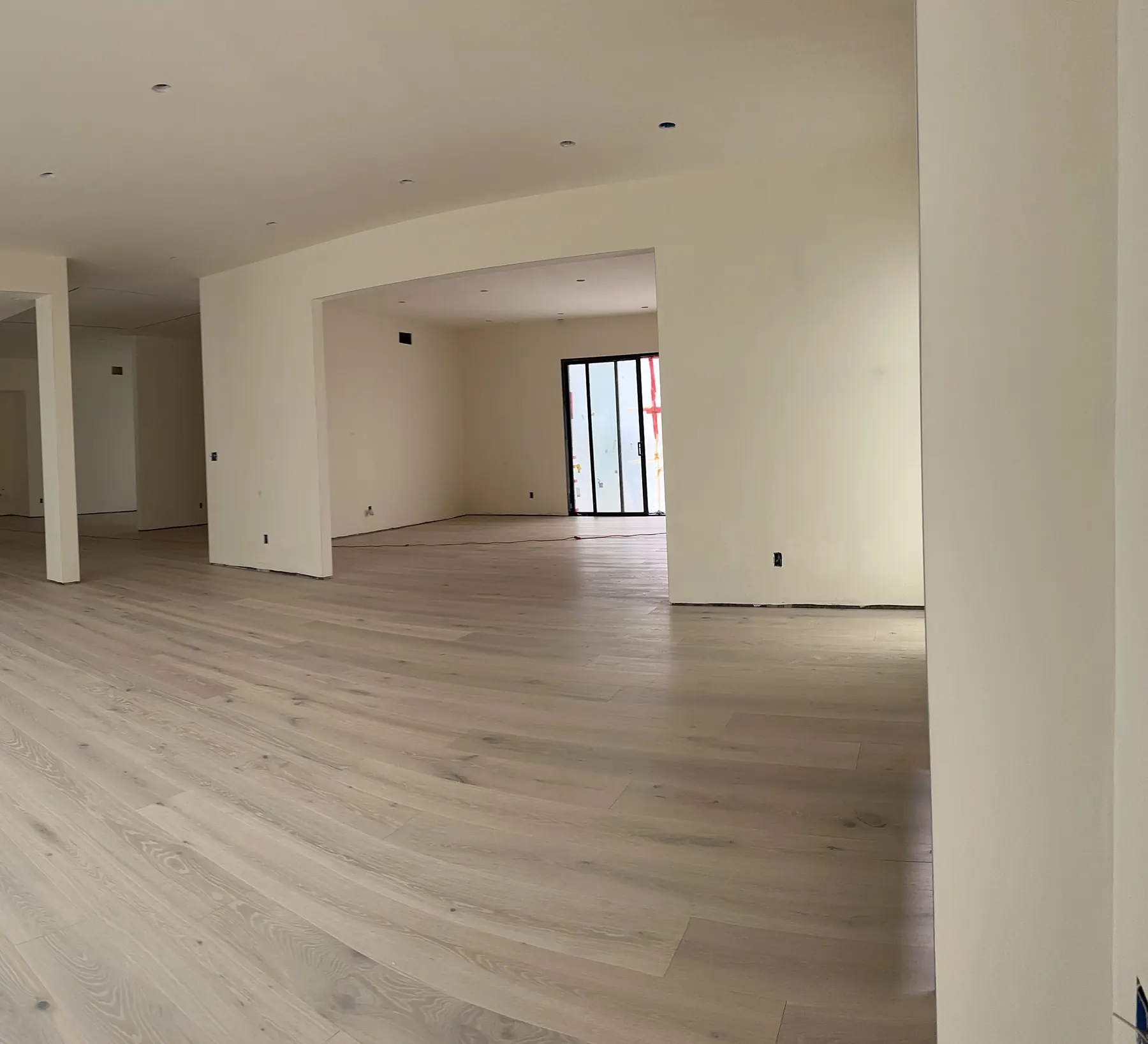 Open living area with new wood flooring installed