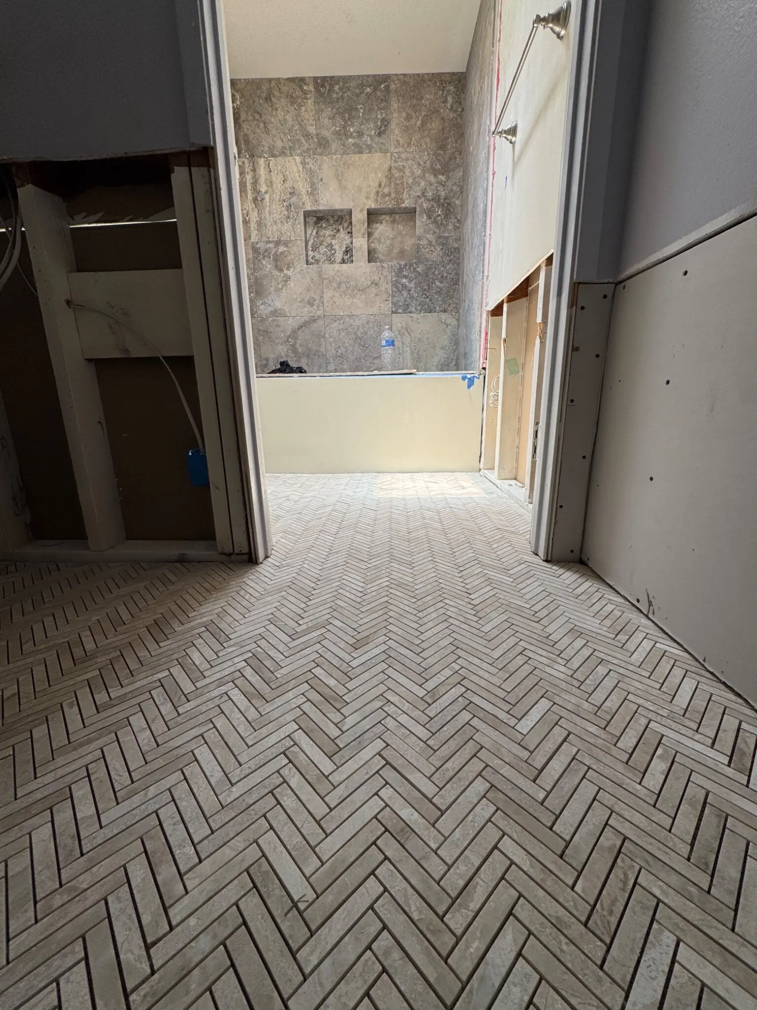 Tile and wall installation in progress in the Irvine main bathroom