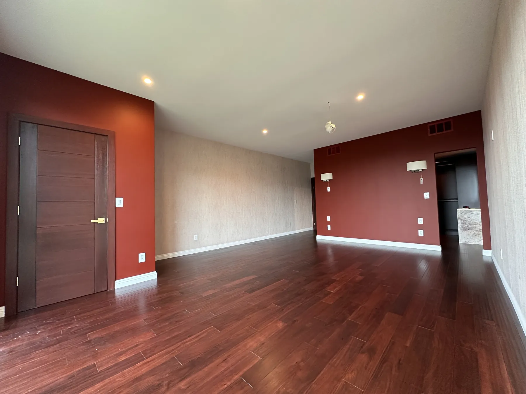 Bedroom with wood flooring and accent walls
