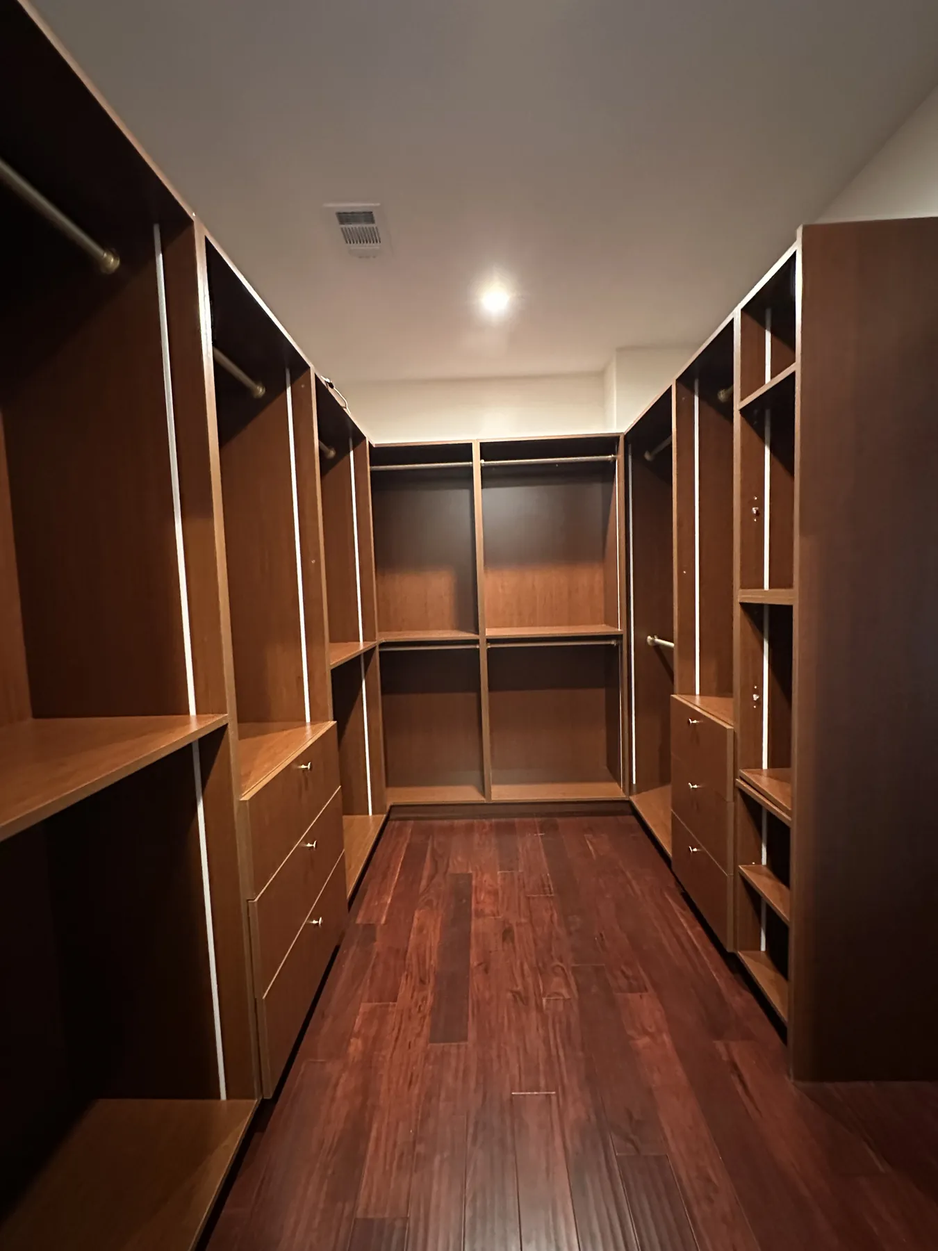 Walk-in closet with built-in wood shelving